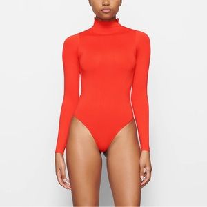 SKIMS Essential Mockneck Long Sleeve Bodysuit in “Fire”